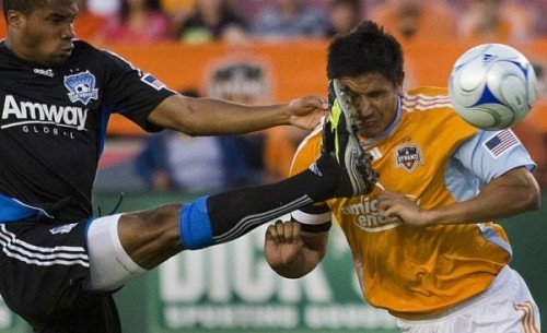 Houston Dynamo forward Brian Ching scores on a header in the first half despite a boot to the face from the San Jose Earthquakes' Ryan Johnson at Robertson Stadium, Saturday, May 23, 2009, in Houston.  (AP Photo/Houston Chronicle, Smiley N. Pool)  ** MANDATORY CREDIT **